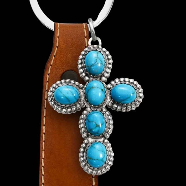 "Our Wild Horses Custom Keychain is truly eye-catching. Crafted from German Silver, it features a beaded edge and six simulated turquoise stones. This is truly a timeless piece. This keychain comes with a genuine leather fob and ring. The leather fob